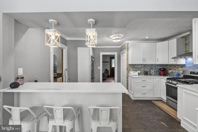 a kitchen with a stove and white cabinets