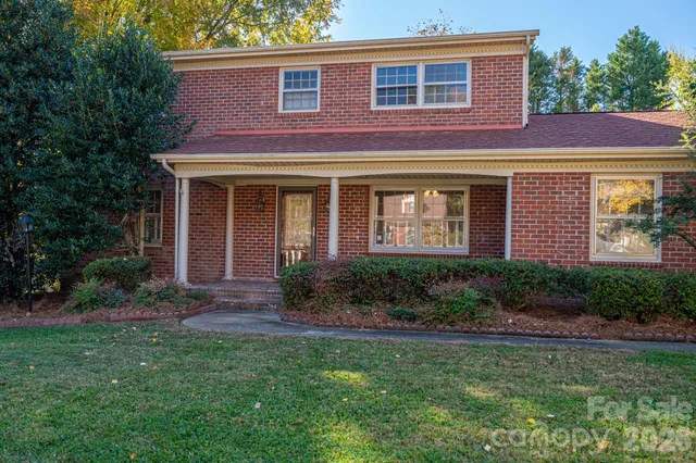 a view of an empty room with a window and fireplace