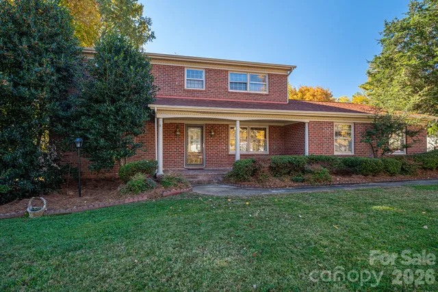 an empty room with wooden floor and ceiling fan