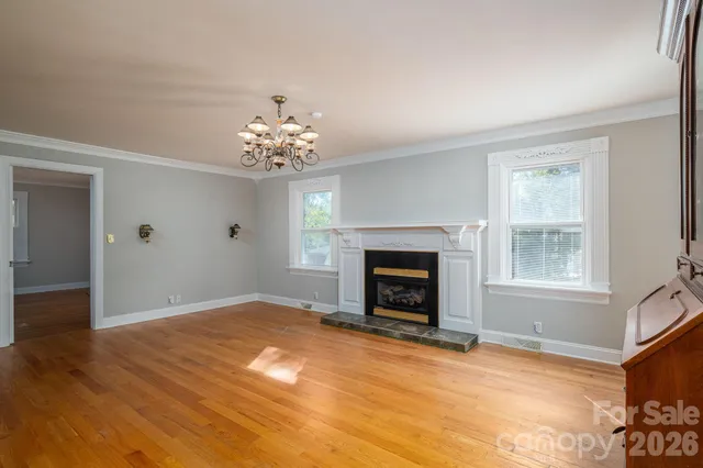 a view of a brick house with a large windows and flower plants
