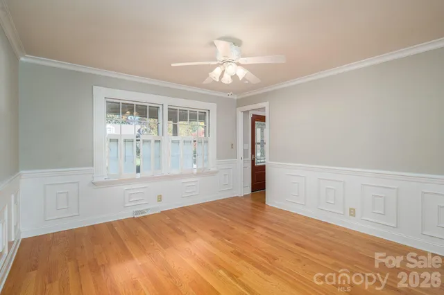 a view of a house with a yard and tree s