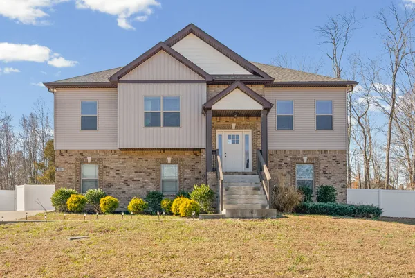 a front view of a house with a yard