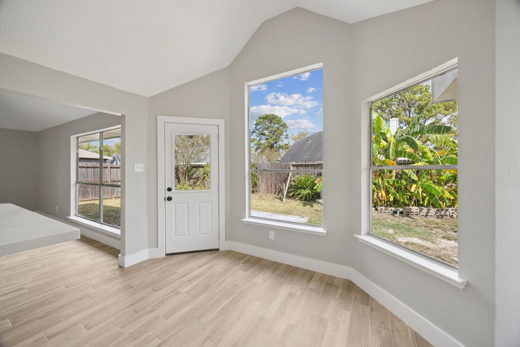 2942 Waterloo Road Pearland, TX 77581 - Photo 11 of 22 a view of an empty room with wooden floor and a window