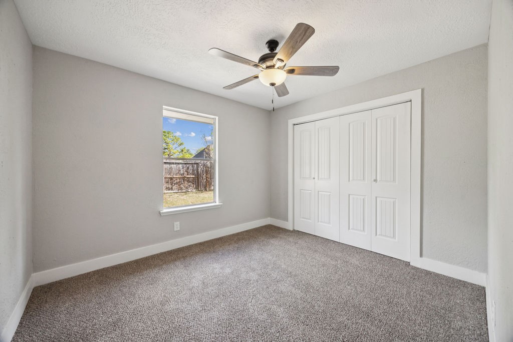 2942 Waterloo Road Pearland, TX 77581 - Photo 17 of 22 a view of an empty room with chandelier fan
