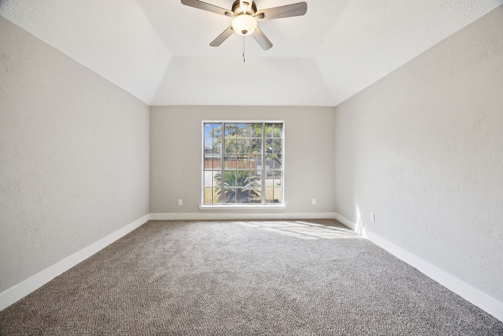 2942 Waterloo Road Pearland, TX 77581 - Photo 18 of 22 an empty room with a window and a ceiling fan