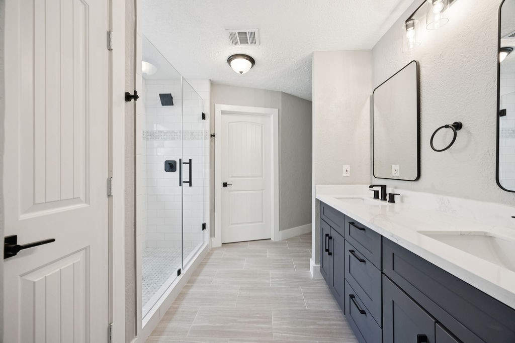 2942 Waterloo Road Pearland, TX 77581 - Photo 19 of 22 a bathroom with a double vanity sink double mirror