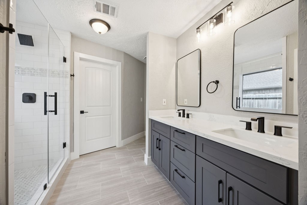 2942 Waterloo Road Pearland, TX 77581 - Photo 20 of 22 a bathroom with a double vanity sink mirror and double