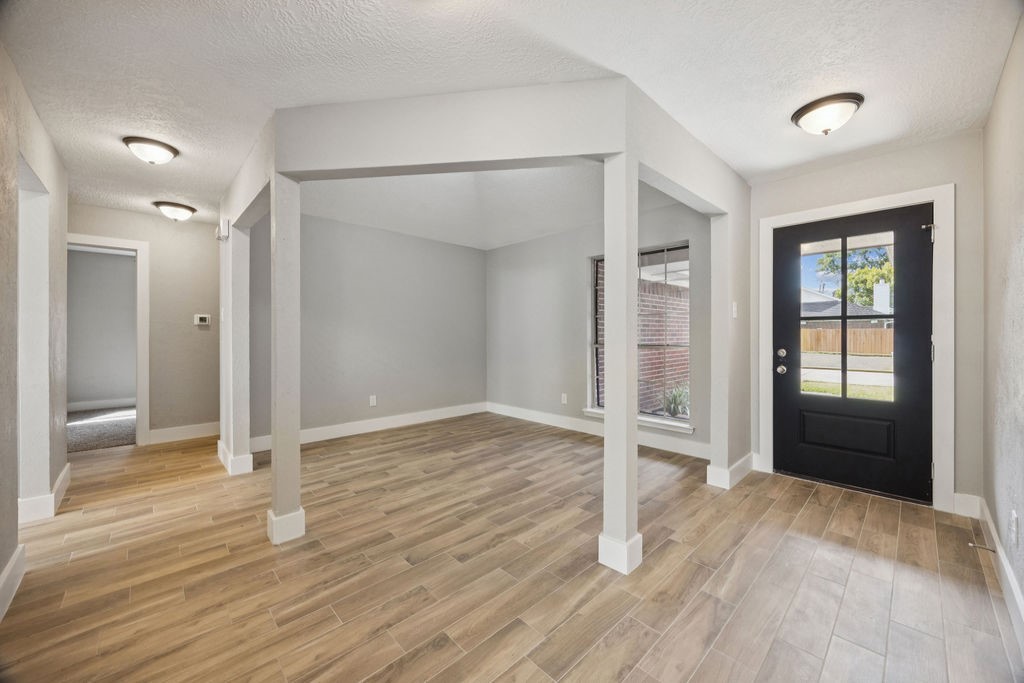 2942 Waterloo Road Pearland, TX 77581 - Photo 3 of 22 wooden floor in an empty room with a window
