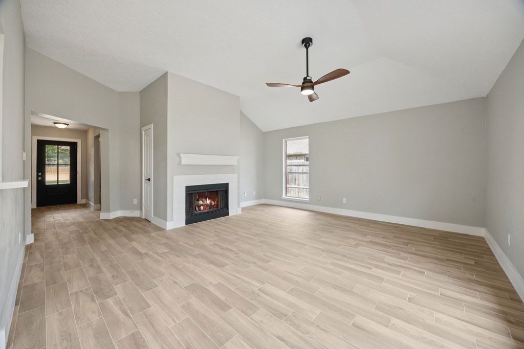 2942 Waterloo Road Pearland, TX 77581 - Photo 4 of 22 a view of empty room with wooden floor and fireplace