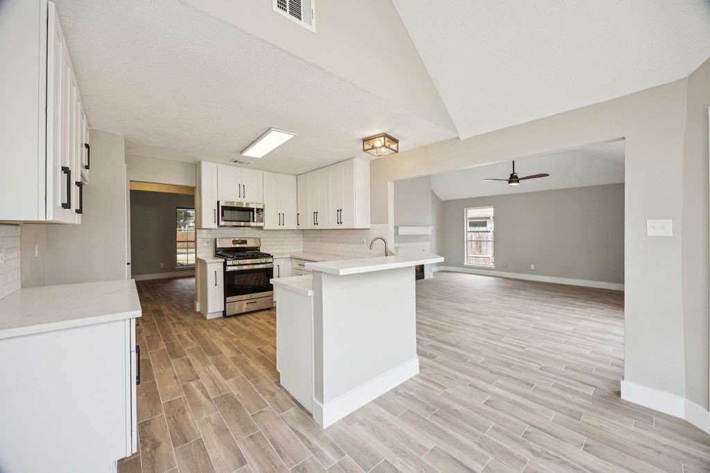 2942 Waterloo Road Pearland, TX 77581 - Photo 5 of 22 a kitchen with a refrigerator and a stove top oven