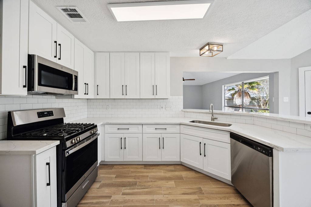 2942 Waterloo Road Pearland, TX 77581 - Photo 8 of 22 a kitchen with cabinets stainless steel appliances and a window