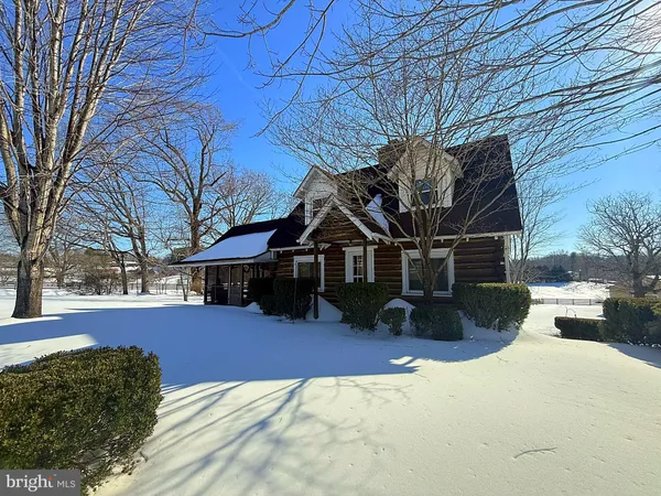 a view of a house with a yard covered in snow
