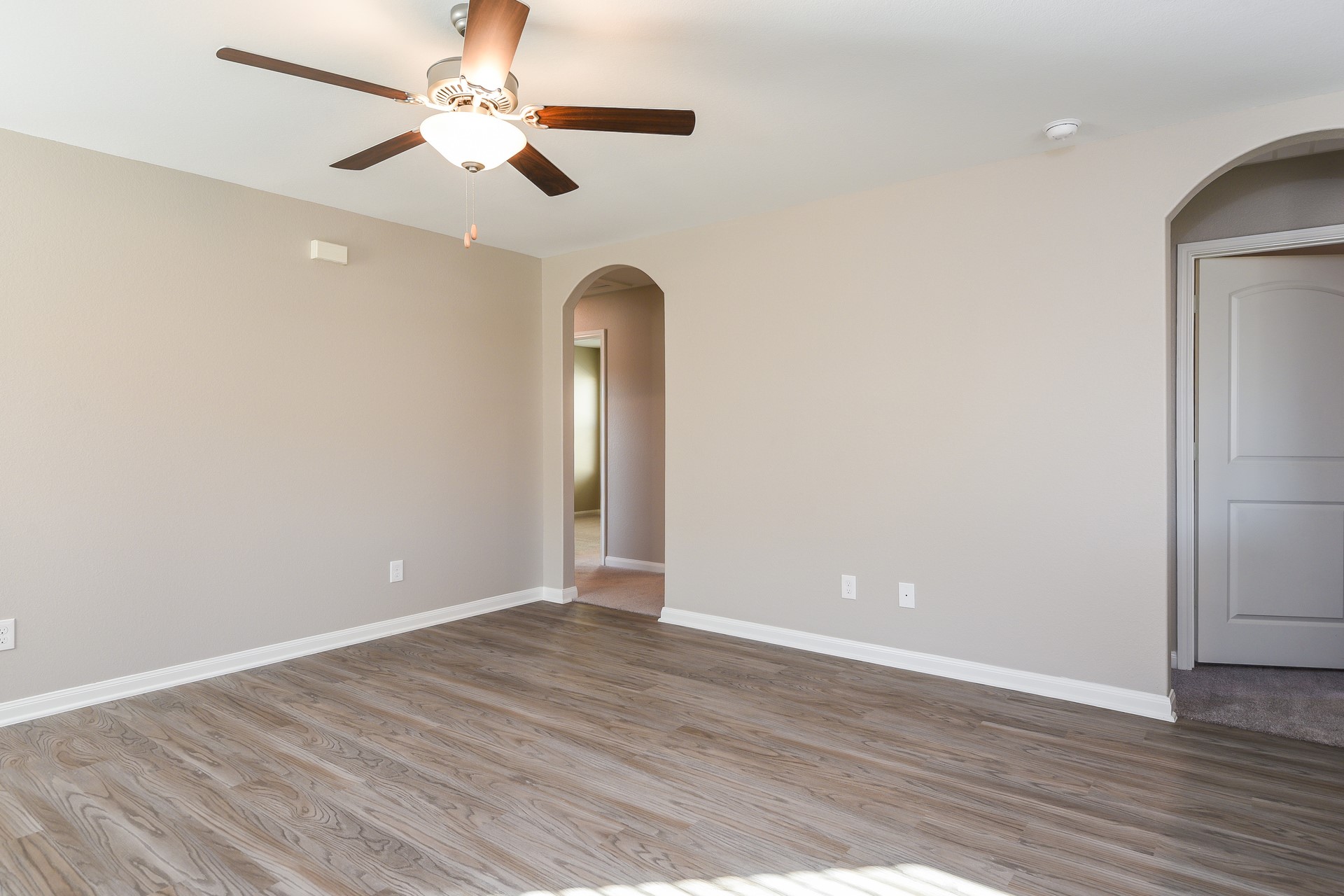 28041 Irving Drive Magnolia, TX 77355 - Photo 12 of 16 an empty room with wooden floor chandelier fan and closet area
