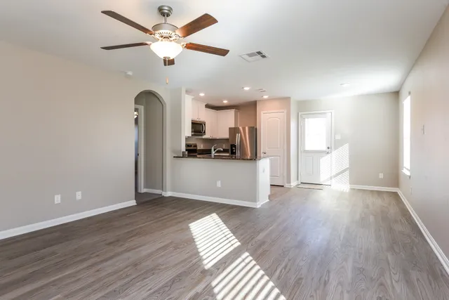 a view of a kitchen with a sink and stainless steel appliances