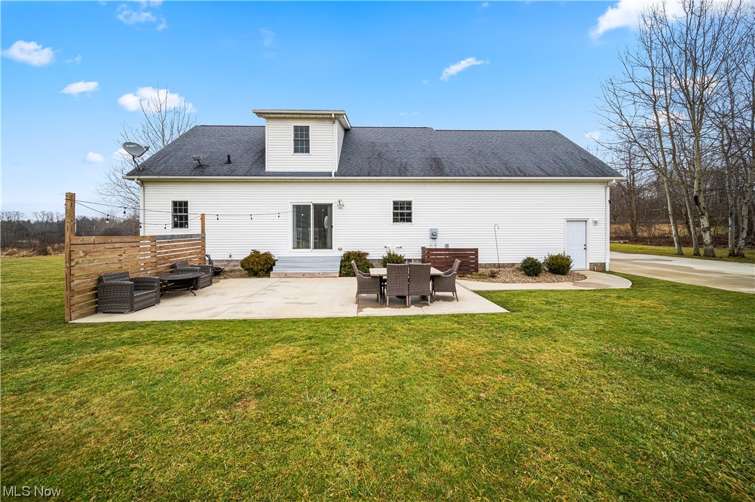16236 Ravenna Road Burton, OH 44021 - Photo 26 of 29 Back of house with a lawn and a patio area