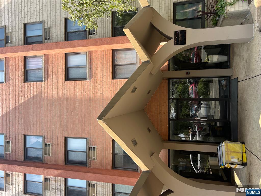 77 Prospect Avenue, Unit 6H Hackensack, NJ 07601 - Photo 14 of 15 a front view of a building with parking