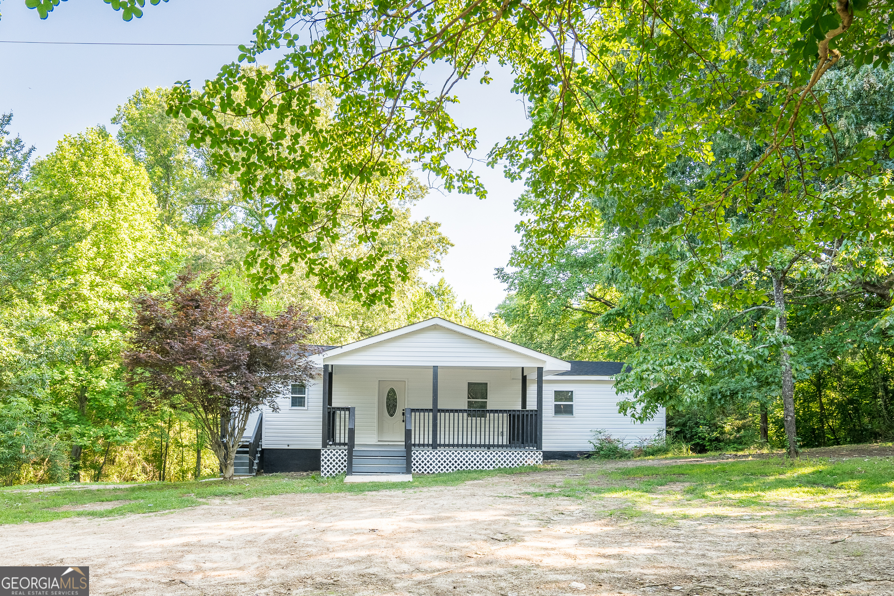635 Good Hope Road Northeast Dalton, GA 30721 - Photo 1 of 1 a front view of a house with a garden and trees