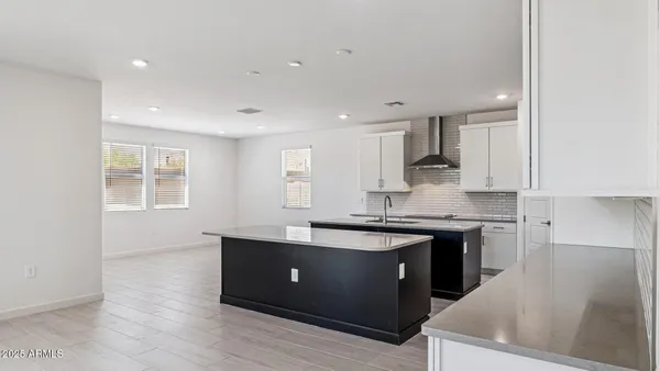 a kitchen with kitchen island sink and refrigerator