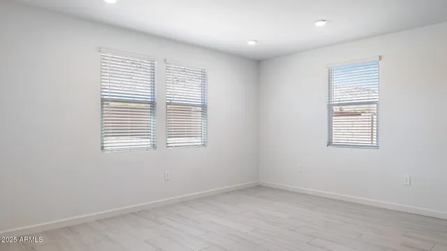 an empty room with a bathroom and a window