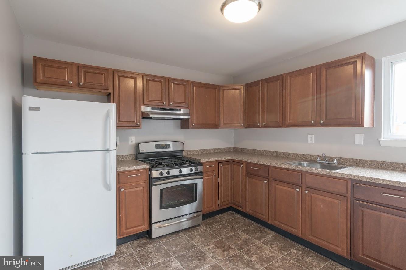 902 Arion Park Road Baltimore, MD 21229 - Photo 8 of 19 a kitchen with a white stove top oven and refrigerator