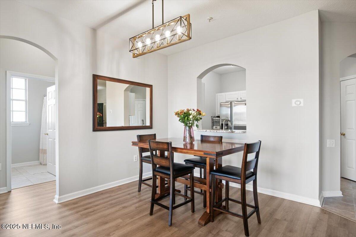 7990 Baymeadows Road East, Unit 913 Jacksonville, FL 32256 - Photo 15 of 70 a view of a dining room with furniture and wooden floor