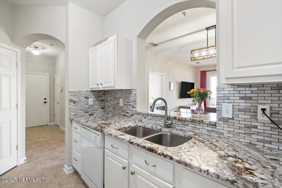 7990 Baymeadows Road East, Unit 913 Jacksonville, FL 32256 - Photo 20 of 70 a kitchen with a sink and cabinets