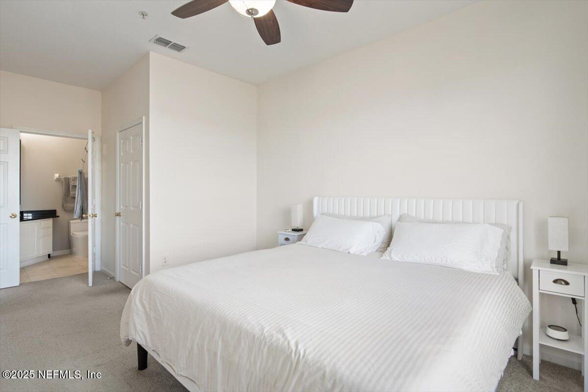 7990 Baymeadows Road East, Unit 913 Jacksonville, FL 32256 - Photo 27 of 70 a bedroom with a bed and painting on the wall