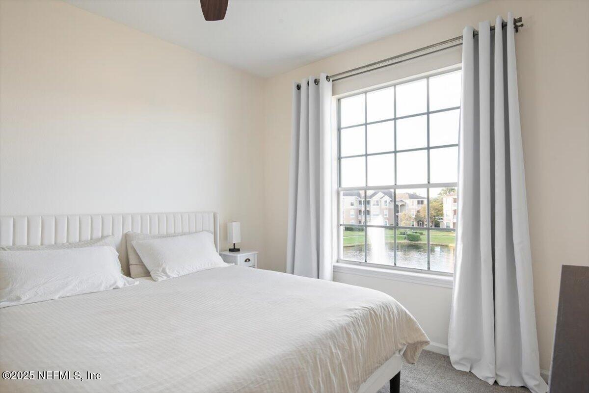 7990 Baymeadows Road East, Unit 913 Jacksonville, FL 32256 - Photo 28 of 70 a bedroom with a large bed and a large window