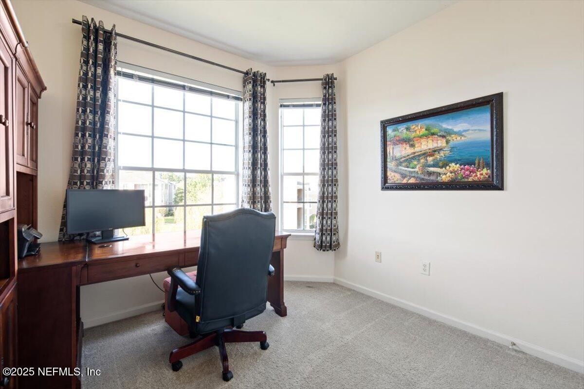 7990 Baymeadows Road East, Unit 913 Jacksonville, FL 32256 - Photo 32 of 70 a view of a workspace with furniture and a window