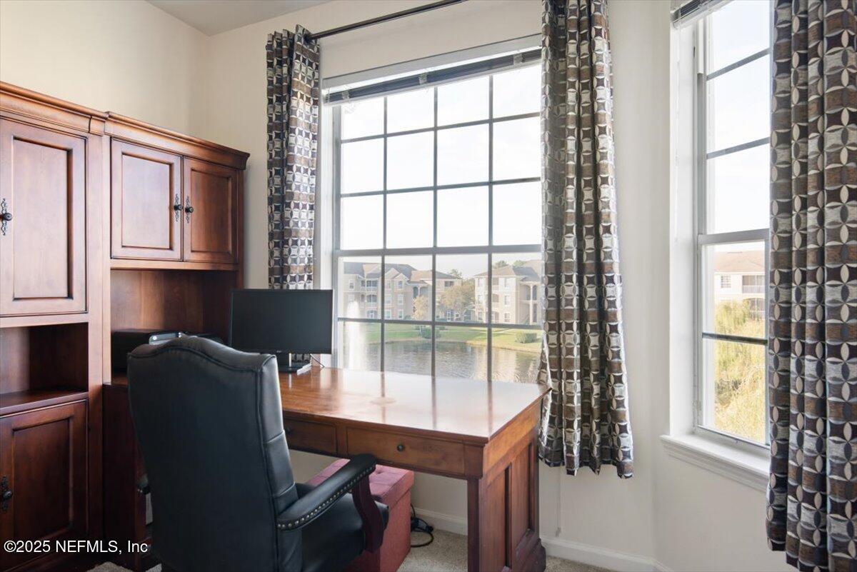 7990 Baymeadows Road East, Unit 913 Jacksonville, FL 32256 - Photo 33 of 70 a dining room with furniture and a window