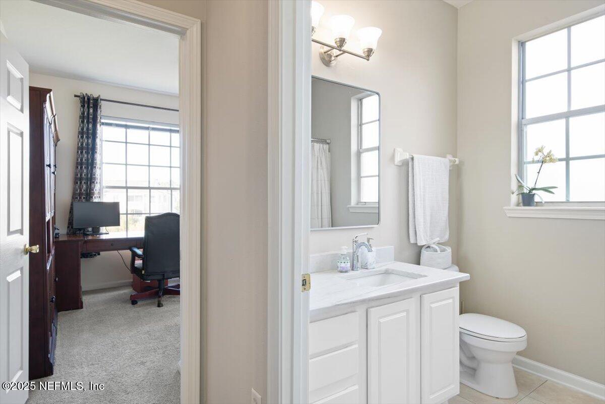 7990 Baymeadows Road East, Unit 913 Jacksonville, FL 32256 - Photo 38 of 70 a bathroom with a toilet a sink and a window