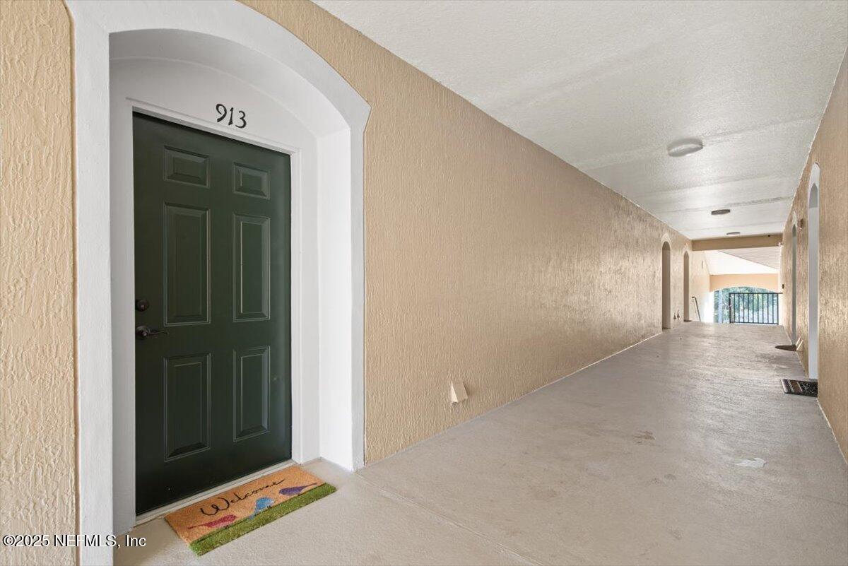 7990 Baymeadows Road East, Unit 913 Jacksonville, FL 32256 - Photo 4 of 70 a view of a hallway to a livingroom and a window