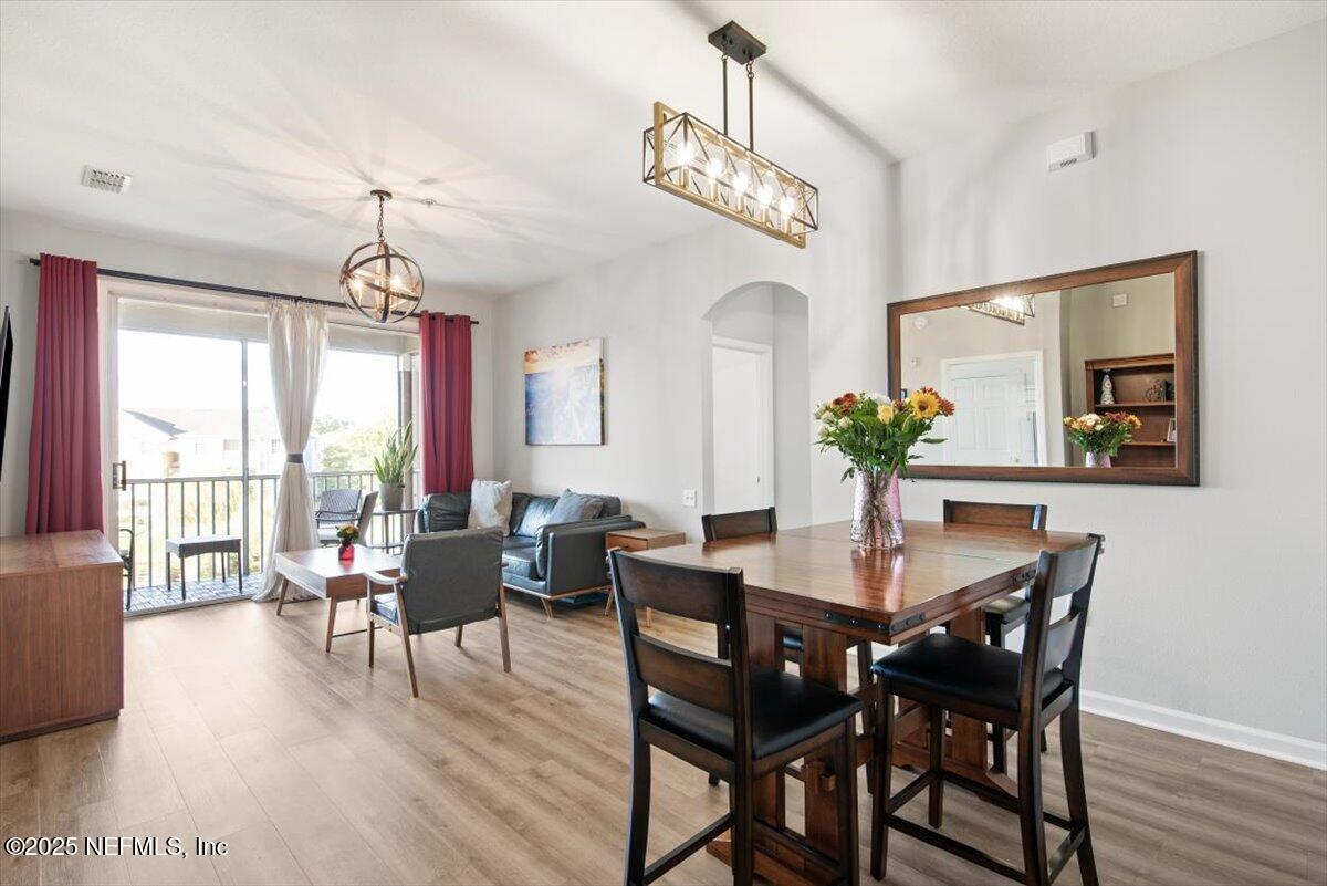 7990 Baymeadows Road East, Unit 913 Jacksonville, FL 32256 - Photo 9 of 70 a view of a dining room with furniture window and wooden floor