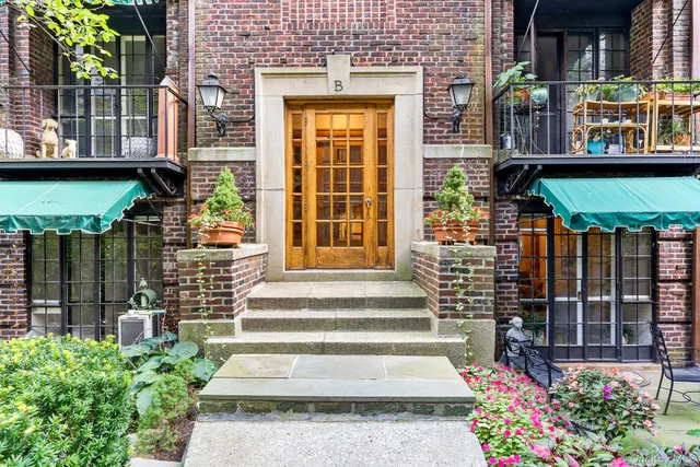 a front view of a house with a garden