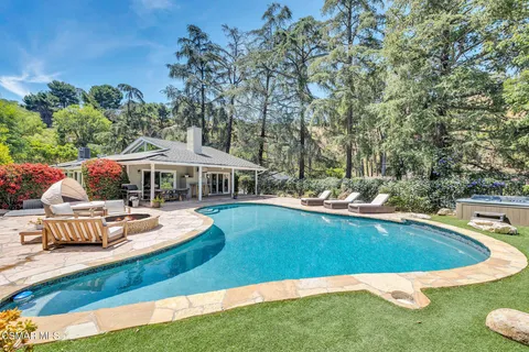 a view of a swimming pool and lounge chairs