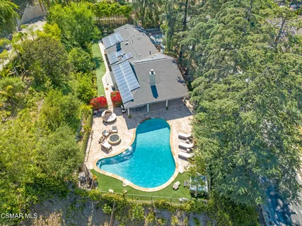 an aerial view of a house with a garden and trees