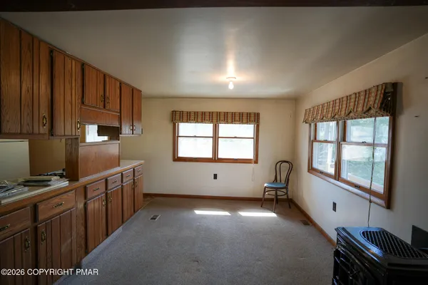 a kitchen with windows and cabinet