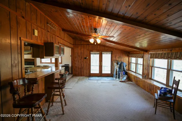 a view of a room with furniture and window