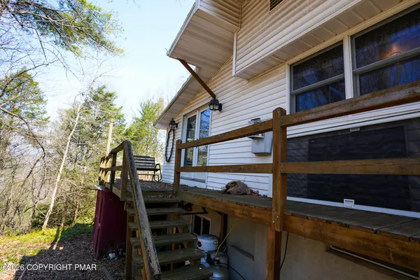 a view of a house with backyard and deck