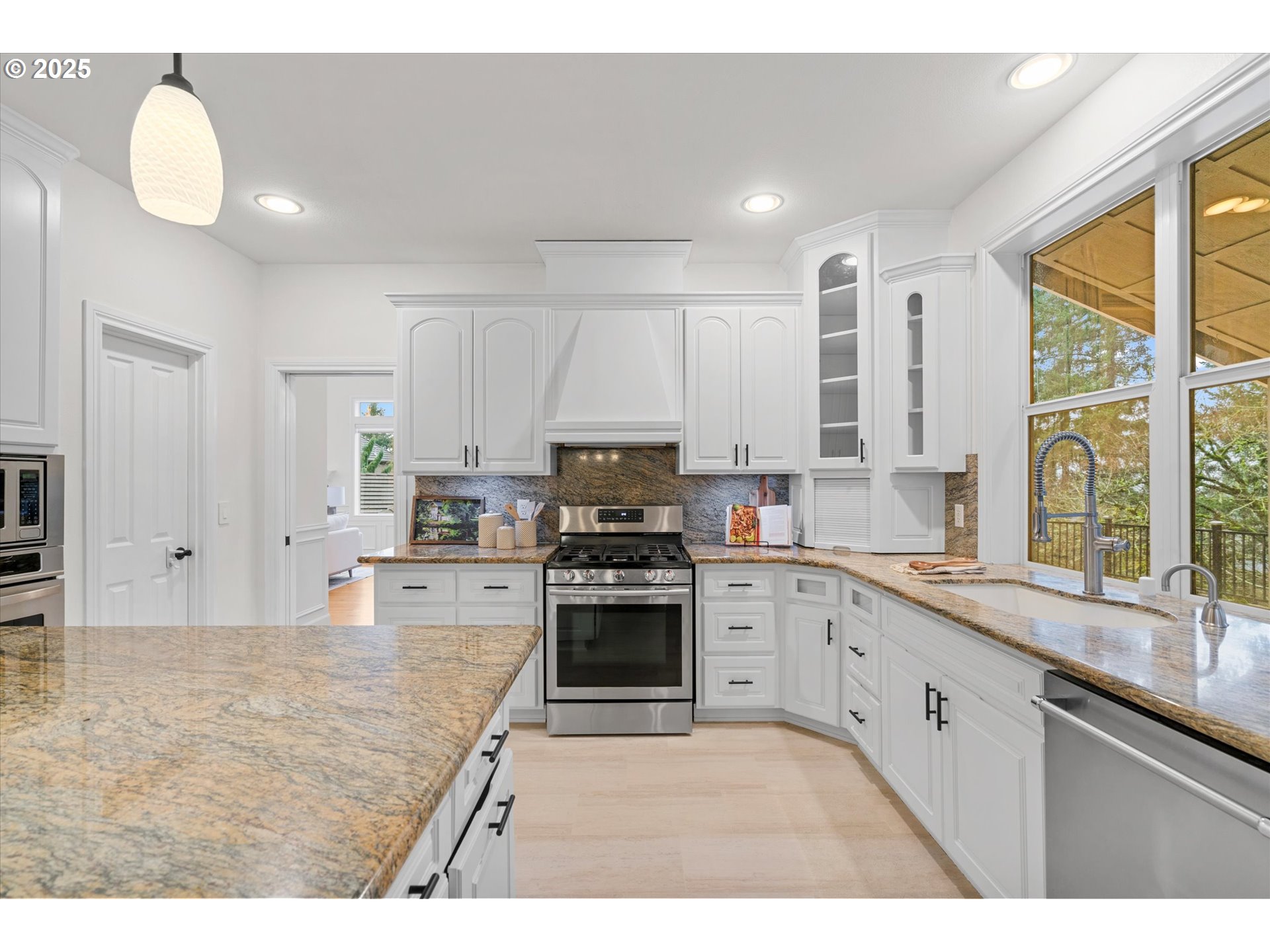 2711 Northwest 28th Circle Camas, WA 98607 - Photo 12 of 45 a kitchen with stainless steel appliances granite countertop a stove a sink and a granite counter tops