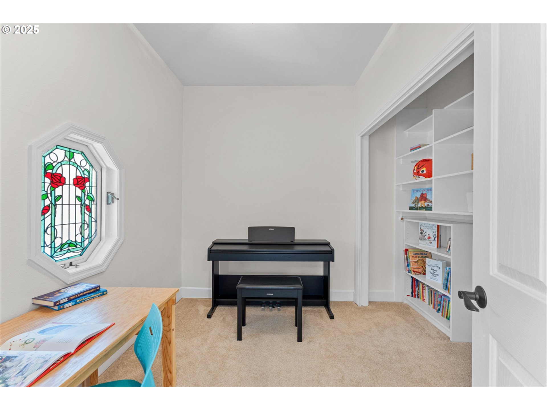 2711 Northwest 28th Circle Camas, WA 98607 - Photo 31 of 45 a living room with a baby crib furniture a rug and a book shelf