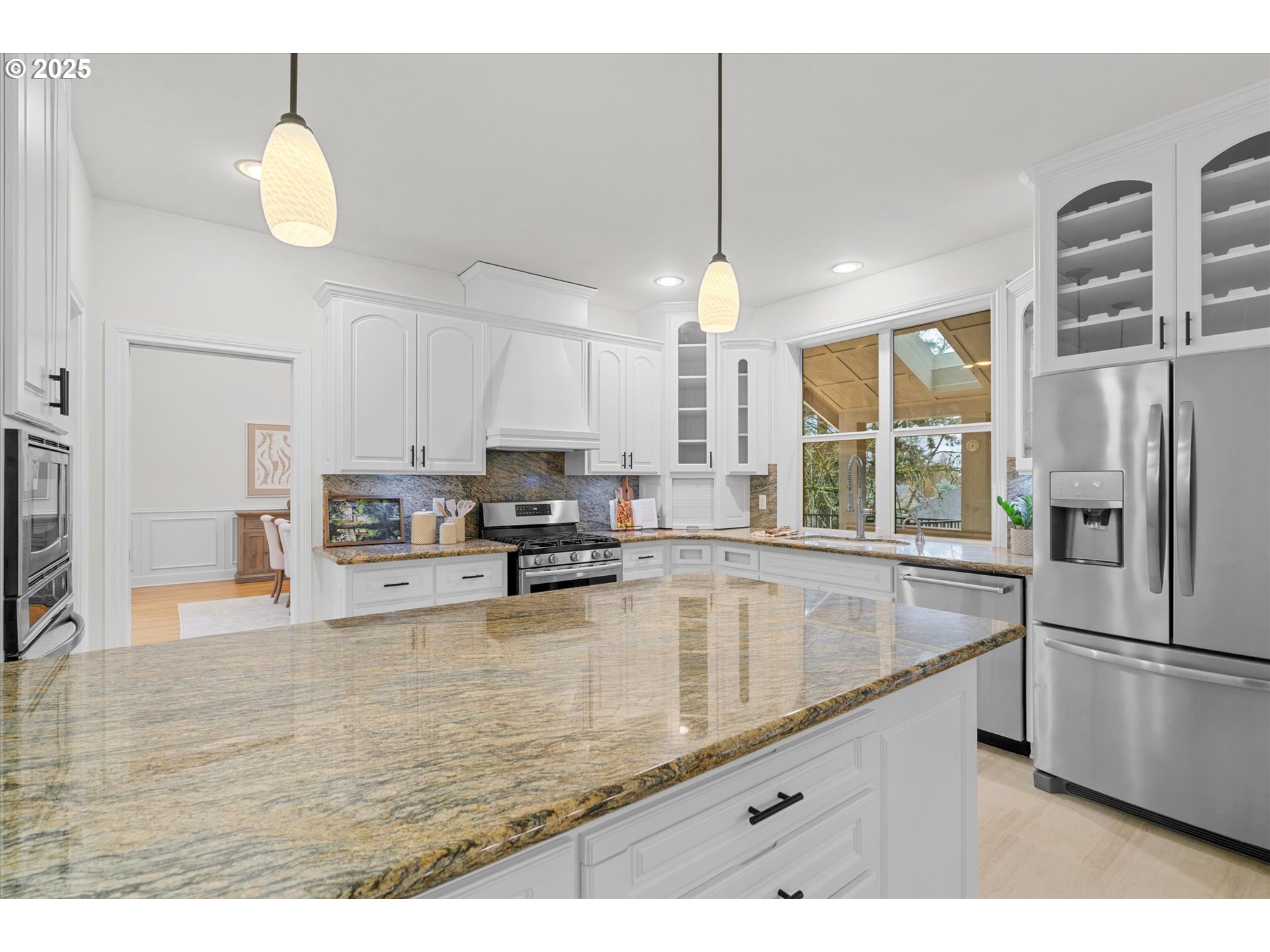 2711 Northwest 28th Circle Camas, WA 98607 - Photo 9 of 45 a kitchen with stainless steel appliances granite countertop a sink a stove and refrigerator