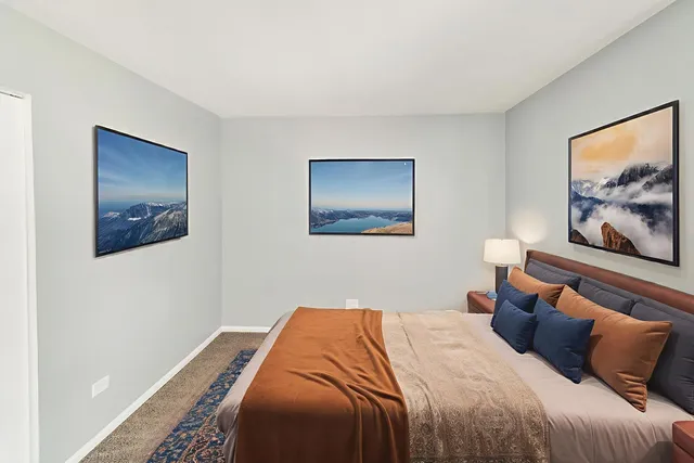 a bedroom with a bed and wall painting