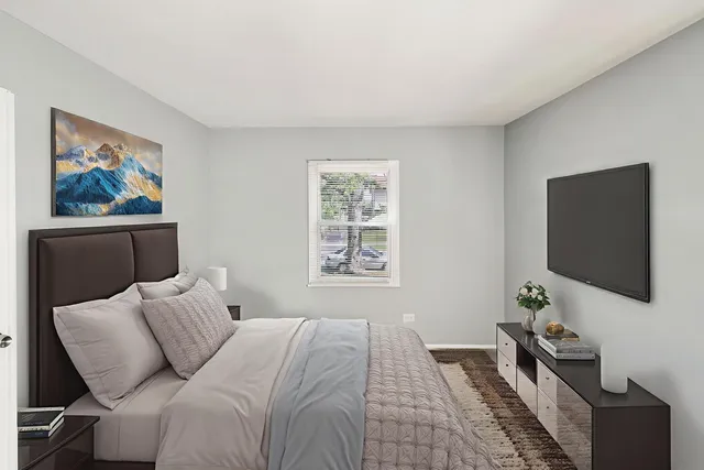 a bedroom with a bed and a flat screen tv