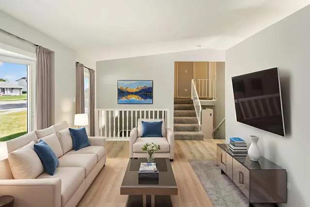 a living room with furniture a flat screen tv and a window