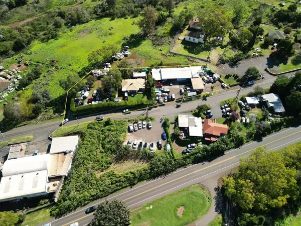 an aerial view of residential houses with outdoor space and street view