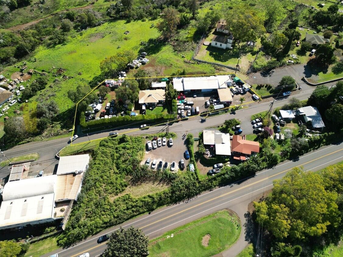an aerial view of residential houses with outdoor space and street view