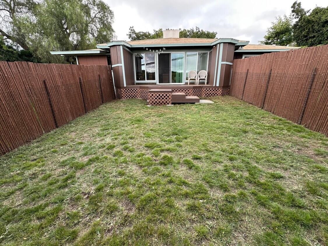 3135 Lower Kula Road Kula, HI 96790 - Photo 11 of 30 a backyard of a house with table and chairs