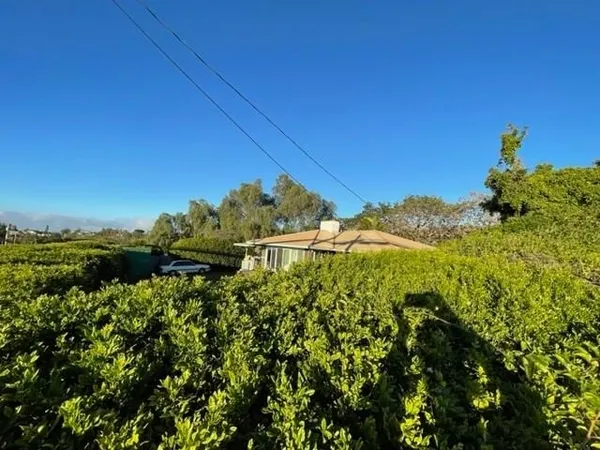 a backyard of a house with table and chairs