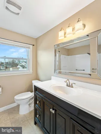 a bathroom with a sink vanity and a toilet